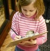 Photo of a girl with a clipboard.